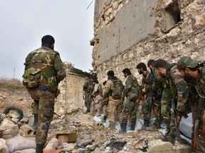 Syrian pro-government troops hold a position in Aleppo's eastern Karm al-Jabal neighborhood as they advance towards al-Shaar neighbourhood on December 5, 2016 during their offensive to retake Syria's second city.