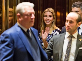 Ivanka Trump(C) waves from the elevator as former US Vice President Al Gore(L) leaves meetings at Trump Tower in New York City on December 5, 2016.