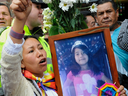 A mourner demands justice holding a picture of Yuliana - a seven-year-old girl who was raped, tortured and murdered - after a mass held in her honour at the Santa Teresita church in Bogota, Colombia, on December 7, 2016.
