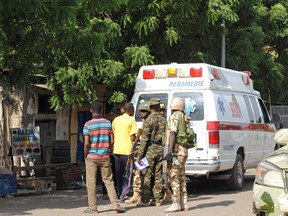 Emergency services and soldiers gather at the scene of a suicide bomb attack on a market in Maiduguri, Nigeria, after two girls approximately seven or eight years old blew themselves, killing themselves and wounding at least 17 others. It is believed Boko Haram is behind the attack as the group has been using women and girls to carry out these horrific attacks.