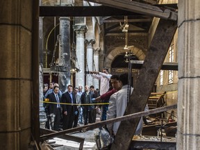 Egyptian security forces inspect the scene of a bomb explosion at the Saint Peter and Saint Paul Coptic Orthodox Church on December 11, in Cairo. The blast killed at least 25 worshippers during Sunday mass inside the Cairo church near the seat of the Coptic pope who heads Egypt's Christian minority, state media said.