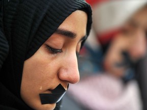 A Bosnian Muslim woman cries as several thousands protestors raise their voice against the killing in eastern Aleppo, Syria, during a rally in Sarajevo, on December 14, 2016.