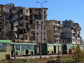 Buses which will be used to evacuate rebel fighters and their families from rebel-held areas of Aleppo are seen waiting on December 15, 2016