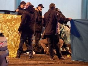 Italian police and forensics experts gather around the body of suspected Berlin truck attacker Anis Amri after he was shot dead in Milan on Friday.