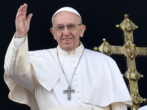 Pope Francis waves from the balcony of St Peter's basilica during the traditional "Urbi et Orbi" Christmas message to the city and the world, on December 25, at St Peter's square in Vatican. Pope Francis offered his thoughts to victims of terrorism in his annual Christmas address, days after the truck attack that left 12 dead at a festive Berlin market.