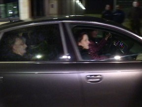 An image grab taken from an AFPTV video shows a car allegedly carrying Jacqueline Sauvage, a woman sentenced to ten years in prison for murdering her violent husband, leaving the prison of Reau, southeast of Paris on December 28, 2016
