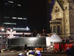 Policemen stand next to a truck that crashed into a christmas market in Berlin on Monday.