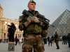 A soldier stands guard outside the Louvre museum, in Paris, Friday, Dec. 30, 2016. With a day to go before New Year's Eve final countdown, France's Interior and Defense Ministers reassured tourists in the capital and insisted security forces were in place to protect them.