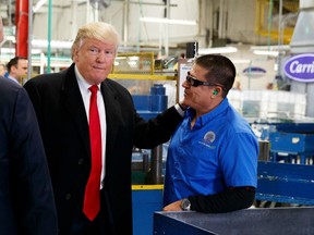 President-elect Donald Trump talks with workers during a visit to the Carrier factory, Thursday, Dec. 1, 2016, in Indianapolis, Ind.