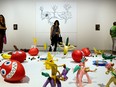 Visitors look at various art installations on display during Art Basel Miami Beach in Miami, Florida, U.S., on Friday, Dec. 2, 2016.