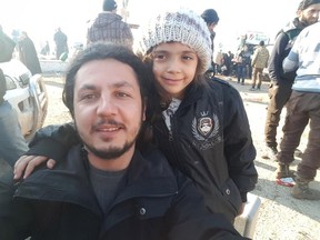 Bana Alabed, right, with an unidentified man in a photo posted by the Humanitarian Relief Foundation on Monday. The NGO said Alabed was rescued safely from Aleppo.