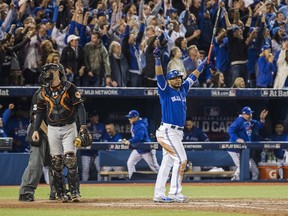 Toronto Blue Jays' Edwin Encarnacion, right, celebrates after hitting a walk-off three-run home run as Baltimore Orioles' Matt Wieters walks off the field during 11th inning American League wild-card game action in Toronto, Tuesday, Oct. 4, 2016.