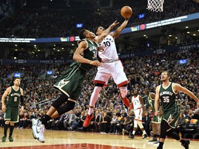 Toronto Raptors guard DeMar DeRozan is fouled on his way to the net by Milwaukee Bucks forward Giannis Antetokounmpo during the first half in Toronto on Monday. The Raptors routed the Bucks 122-100.