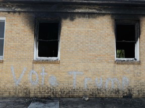 In this Wednesday, Nov. 2, 2016 file photo, "Vote Trump" is spray painted on the side of the fire damaged Hopewell M.B. Baptist Church in Greenville, Miss.
