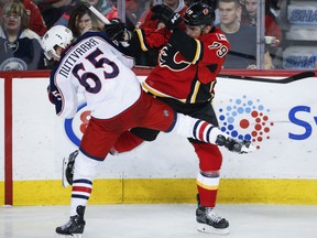 Markus Nutivaara, left, of the Columbus Blue Jackets finds himself hitting the deck after colliding with Micheal Ferland of the Calgary Flames during NHL action Friday night in Calgary. The Blue Jackets made it eight straight wins by virtue of a 4-1 victory over the Flames.