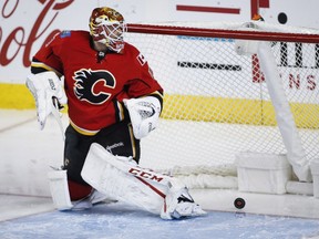 Calgary Flames goalie Brian Elliott looks back at the net as the Tampa Bay Lightning score during the third period of their NHL game in in Calgary on Wednesday, Dec. 14, 2016.