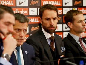 Gareth Southgate, second right, the newly confirmed England soccer team manager listens to Martin Glenn, second left, Chief Executive of the English Football Association who speaks during a press conference in the headquarters of the English FA, at Wembley stadium London, Thursday, Dec. 1, 2016.