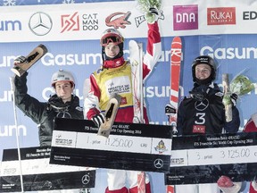 Canada's Mikael Kingsbury, centre, celebrates on the podium after winning the men's moguls World Cup season opener Ruka Kuusamo, Finland on Saturday, Dec. 10, 2016.