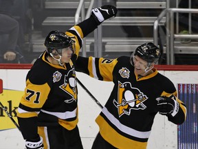 Evgeni Malkin, left, celebrates his overtime goal with Penguins teammate Patric Hornqvist during their game against the Montreal Canadiens in Pittsburgh on Saturday, night. The Penguins won 4-3.