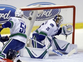 Vancouver Canucks goalie Jacob Markstrom is unable to stop a shot by the Panthers' Aleksander Barkov in the first period of their game Saturday night in Sunrise, Fla.