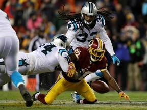 Jamison Crowder of Washington fumbles the ball after being hit by James Bradberry of the Carolina Panthers during Monday night NFL action at Landover, Maryland.