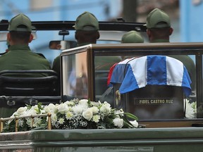 A military jeep tows a trailer with the flag-draped chest containing the remains of former president of Cuba Fidel Castro on December 1, 2016 in Santa Clara, Cuba.