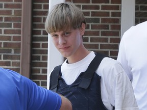 In this June18, 2016 file photo, Dylann Storm Roof is escorted from the Sheby Police Department in Shelby, N.C