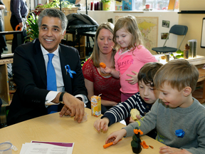 Alberta Minister of Human Services Irfan Sabir (left) plays with children Shana Lee (3-years-old with mom Kristy Lee), Beckett Lee (6-years-old) and Isaac Doren (4-years-old) at MacEwan University's Early Learning and Child Care Lab School