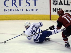 Toronto Maple Leafs' rookie Auston Matthews, left, is tripped up by Arizona Coyotes' Martin Hanzal during NHL action Friday night in Glendale, Ariz. Matthews, a native of Arizona who was making his initial NHL appearance there, had a pair of assists as the Leafs posted a 4-1 victory, their second straight victory.