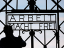 A blacksmith prepares a replica of the Dachau Nazi concentration camp gate, with the writing 