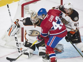 Daniel Carr of the Montreal Canadiens gets in close quarters with Anaheim Ducks' goaltender Jonathan Bernier during NHL action in Montreal on Tuesday night. Lending assistance to Bernier is defenceman Hampas Lindholm. The Canadiens were 5-1 winners, outshooting the Ducks 34-13 in the process.