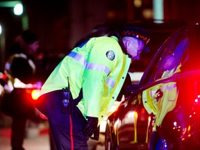Police officers stop motorists during a RIDE program spot-check on Lakeshore Blvd. in Toronto Thursday, December 13, 2012.