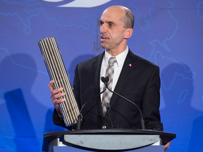 Candidate Steven Blaney holds a fuel bundle for a nuclear power plant during the Conservative leadership candidates' bilingual debate in Moncton, N.B. on Tuesday, Dec. 6, 2016.