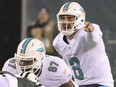 Miami Dolphins quarterback Matt Moore directs the offence as he waits for the snap in the first half against the New York Jets on Saturday night in East Rutherford, N.J.