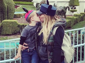 The image that has riled up so many social media commenters, in which Duff shares a kiss with son Luca.
