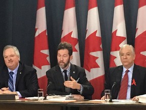 Left to right: Bloc Quebecois MP Luc Thériault, Tory Scott Reid and Liberal Francis Scarpaleggia at a press conference on a House of Commons committee's report on electoral reform.
