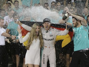 Nico Rosberg of Germany is sprayed with champagne by his team after placing second and becoming 2016 world champion at the Emirates Formula One Grand Prix at the Yas Marina racetrack in Abu Dhabi, United Arab Emirates.