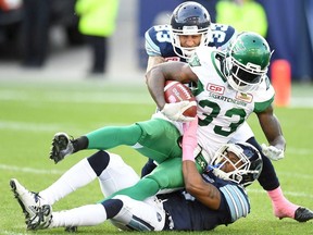 In this Oct. 15 file photo, Saskatchewan Roughriders running back Joe McKnight is tackled by two Toronto Argonauts defenders. McKnight was shot and killed near New Orleans on Dec. 1.