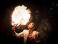 Gabriella Caruso, artistic director of Red Pepper Spectacle Arts, blows a fireball on Augusta Avenue during the the 27th annual Kensington Market Winter Solstice Parade in Toronto, Ontario on Wednesday, December 21, 2016. Revellers parade through the streets and gather at Alexandra Park to mark the longest night of the year.