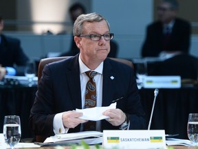 Saskatchewan Premier Brad Wall gets settled in for the Meeting of First Ministers in Ottawa on Friday, Dec. 9, 2016.