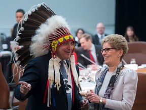 Assembly of First Nations Chief Perry Bellegarde speaks with Ontario Premier Kathleen Wynne before the First Ministers and National Indigenous Leaders meeting in Ottawa, Friday December 9, 2016.