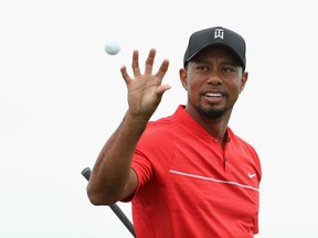 Tiger Woods catches a golf ball on the practice range during the final round of the Hero World Challenge in Nassau, Bahamas on Dec. 4.