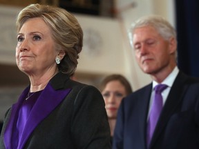 Hillary Clinton, accompanied by her husband former president Bill Clinton, pauses as she concedes the presidential election at the New Yorker Hotel on Nov. 9 in New York City.