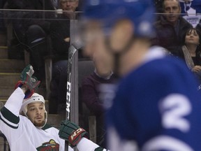 Minnesota Wild right winger Chris Stewart (left) celebrates his goal as Toronto Maple Leafs defenceman Matt Hunwick skates by on Dec. 7.