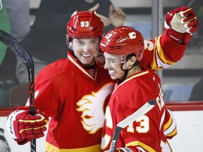 Sam Bennett, left, celebrates his goal with Flames teammate Johnny Gaudreau during second-period action against the Winnipeg Jets in Calgary on Saturday night.