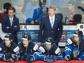 Finland head coach Jukka Rautakorpi, right, looks on from behind the bench during a preliminary round world junior hockey tournament game against the Czech Republic in Montreal on Monday, Dec. 26, 2016. Finland's hockey federation fired the coaching staff after failing to make the tournament's quarter-finals.