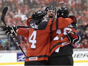 Canada forward Dylan Strome (19) celebrates with forward Matt Barzal (14) and defenceman Thomas Chabot after scoring against Russia during third period of  IIHF World Junior Championship action in Toronto on Monday.