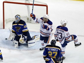 Ryan Nugent-Hopkins (No. 93) of the Edmonton Oilers celebrates his game-winning goal in overtime against St. Louis Blues' goaltender Carter Hutton during NHL action Monday night in St. Louis. The Oilers were 3-2 winners.