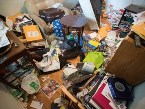 Garbage fills a room of Simon Andrew's rental house on John F. Scott Road.