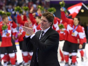 Head coach Mike Babcock of Canada applauds his team following their 3-0 victory in the men's hockey gold-medal game at the 2014 Winter Olympics in Sochi, Russia.